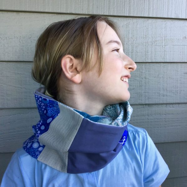 young girl wearing patchwork scarf made of scraps from an old baby blanket